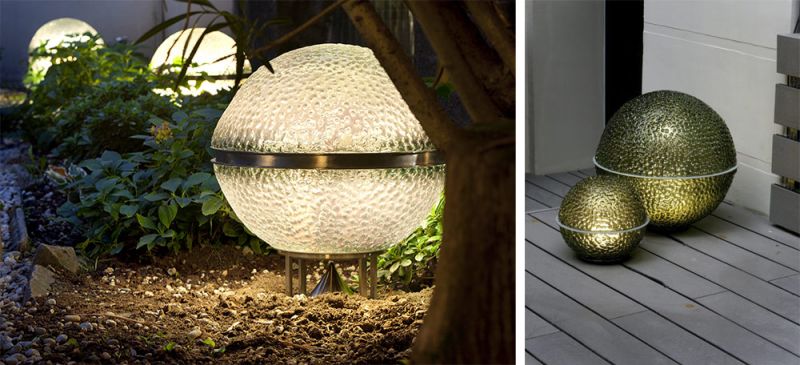 foto de un altavoz lampara de architettura sonora de cristal granulado de color verde botella sobre un jardin jardin